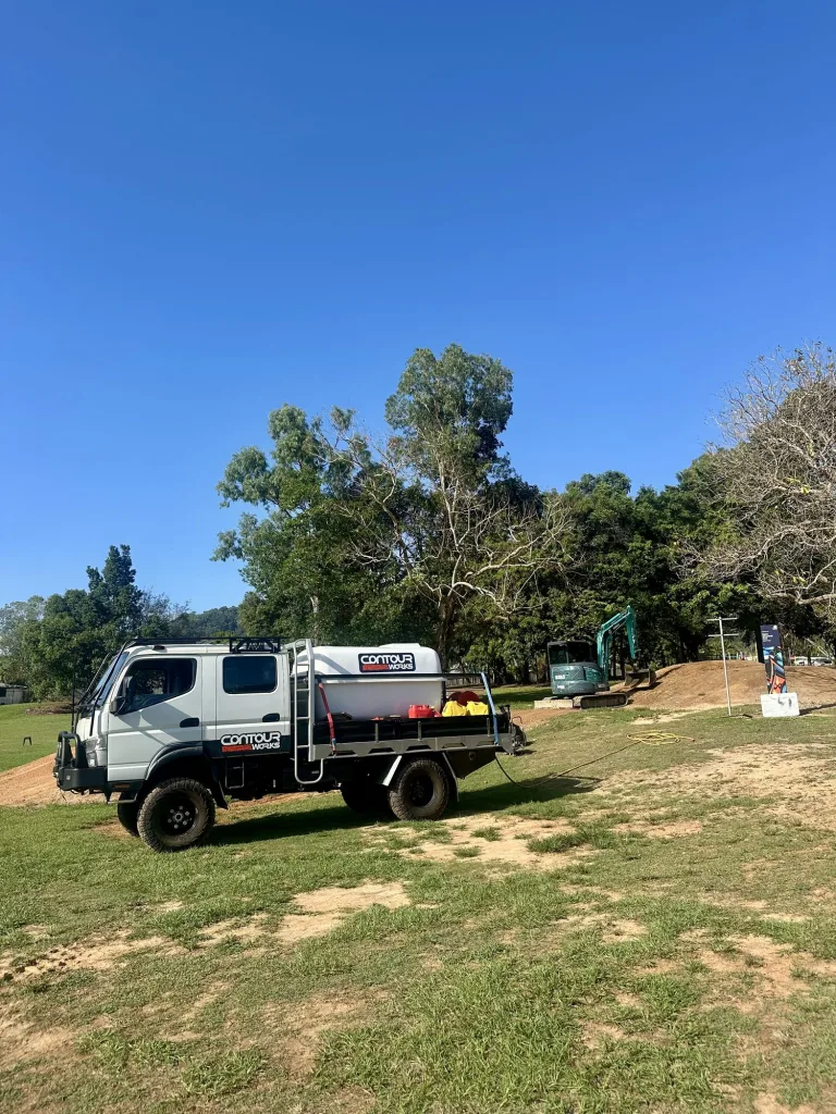 Tipper truck carrying the water cart at a trail head